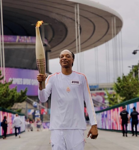 Snoop Dogg holding the Olympic torch.