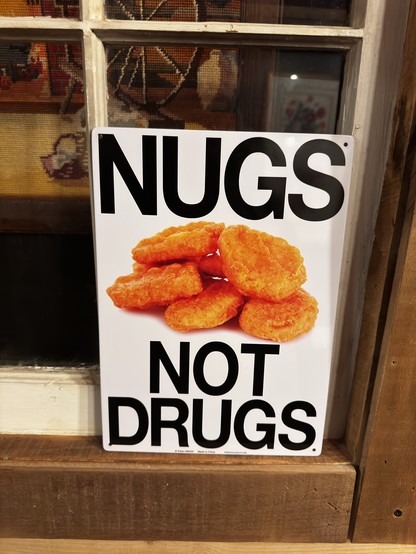 Sign says “Hugs not Drugs”