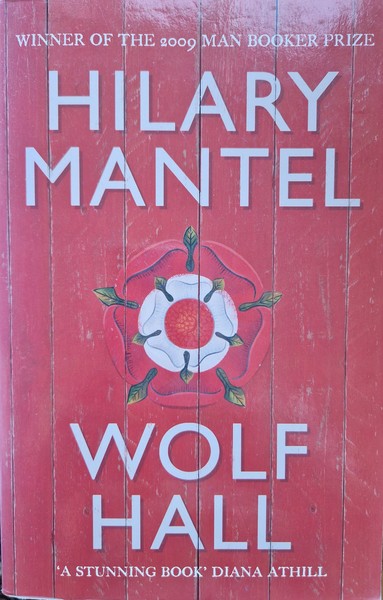 Cover of 'Wolf Hall' by Hillary Mantel, showing red painted vertical planks with the red and white Tudor rose placed centrally.