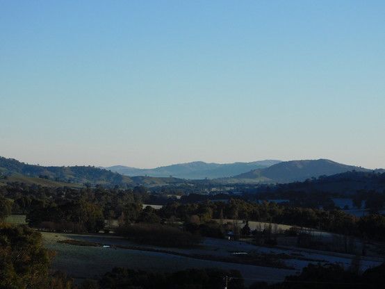 Long view of the valley looking north, still much in shadow with Lake Hume in the distance.