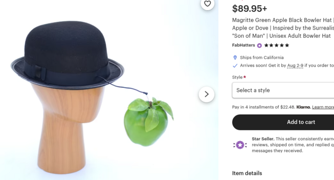A bowler hat with a green apple 