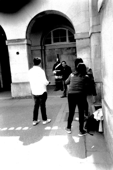 Tourists taking photos with a guard at Horse Guards, Whitehall, London.