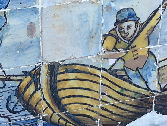 Ceramic tile of a determined rower in a boat