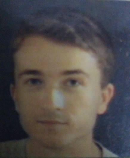 Grainy old picture of a young man with close cropped dark blond hair.