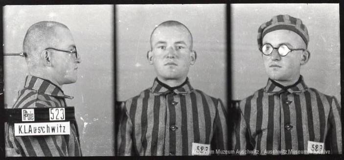 A mugshot registration photograph from Auschwitz. A man with a shaved head wearing a striped uniform photographed in three positions (profile and front with bare head and a photo with a slightly turned head with a hat on). The prisoner number is visible on a marking board on the left.
