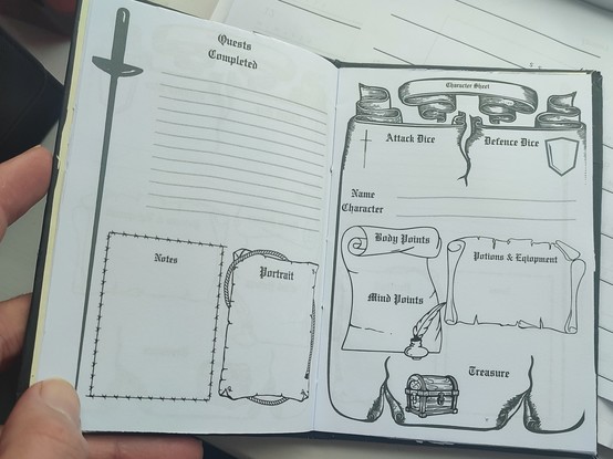 Internal of a notebook containing heroquest character sheets