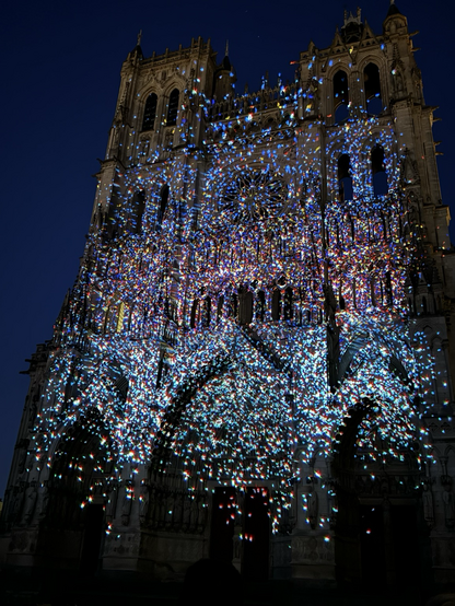 Many dots of light of all colors on Amiens Cathedral