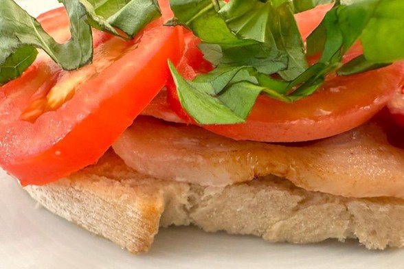 Bacon, tomato and basil on slightly toasted brown bread.