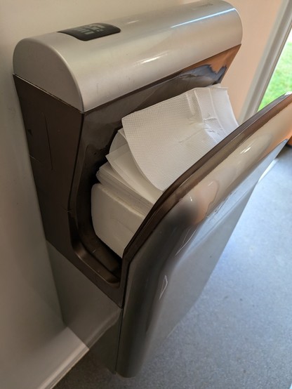 A hand dryer, in which the space where you put your hands is filled with paper towels.