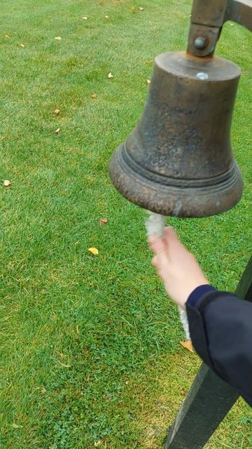 My hand ringing a schoolyard bell much like the gold medalists get to do at the Olympics and Paralympics.