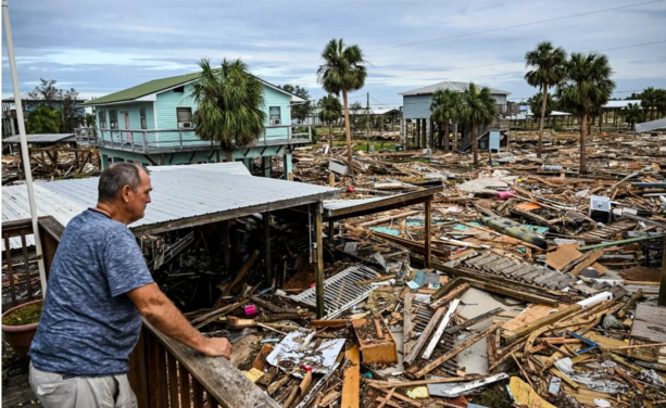 man looking at devastation caused by Helene