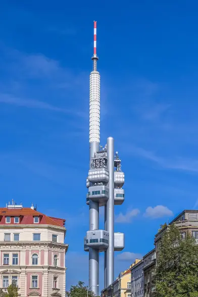 The image features a tall, modern television tower, likely the Žižkov Television Tower, which is located in Prague, Czech Republic. The tower has a distinctive design, characterized by its sleek, futuristic look and is often recognized by its prominent height and antenna structure. The sky appears clear and blue in the background, highlighting the tower against the cityscape.

Image Credits: Wikimedia / Bengt Nyman from Vaxholm, Sweden / CC BY 2.0