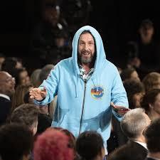 Adam Sandler dons a blue hoodie in an Oscars gag during Conan O'Brien's monologue.