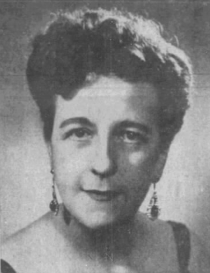 Constance Eberhart in midlife, a white woman with dark curly hair in an updo, wearing drop earrings