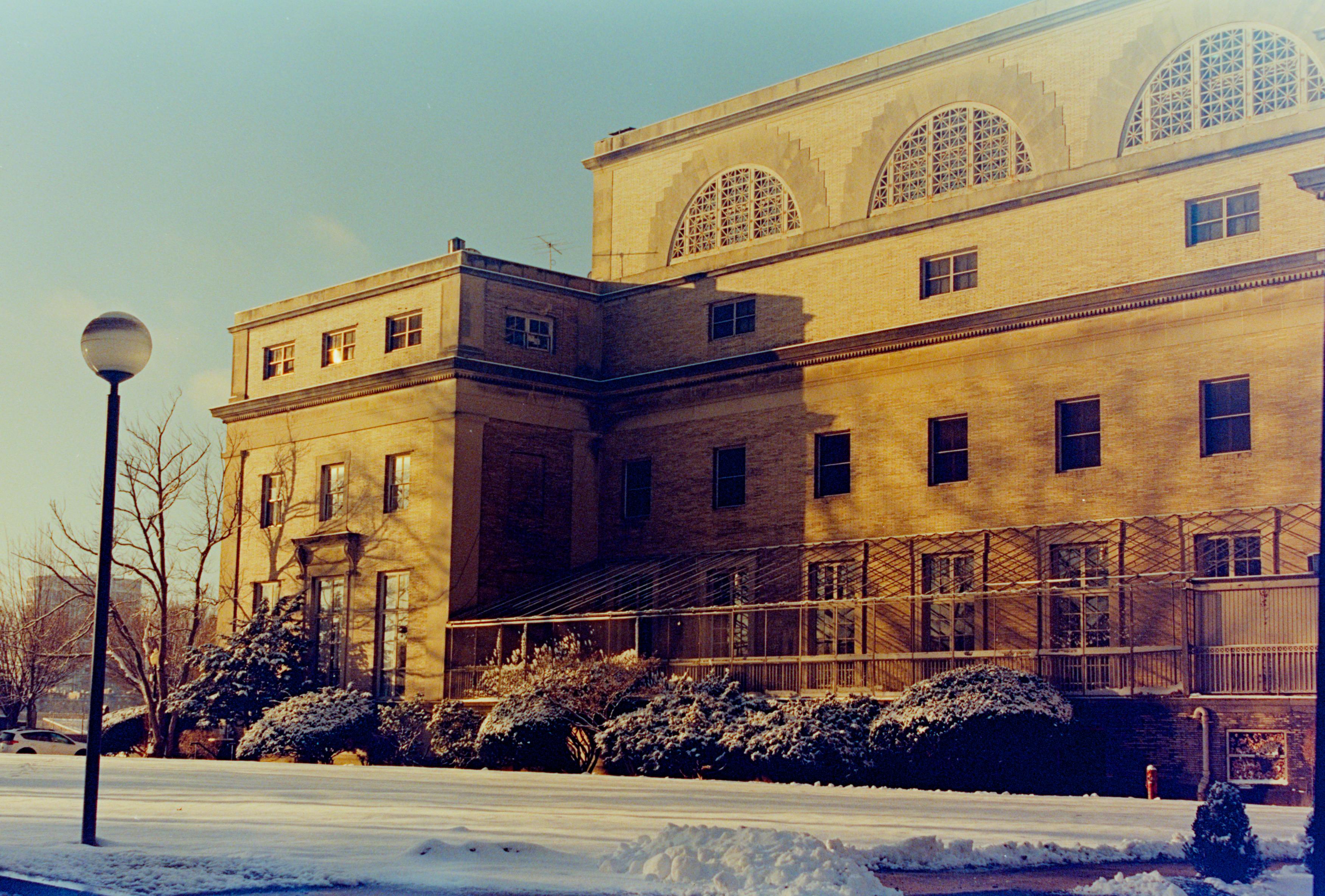 Analog photo of yellow brick building bathed in light. It's kinda underexposed. 