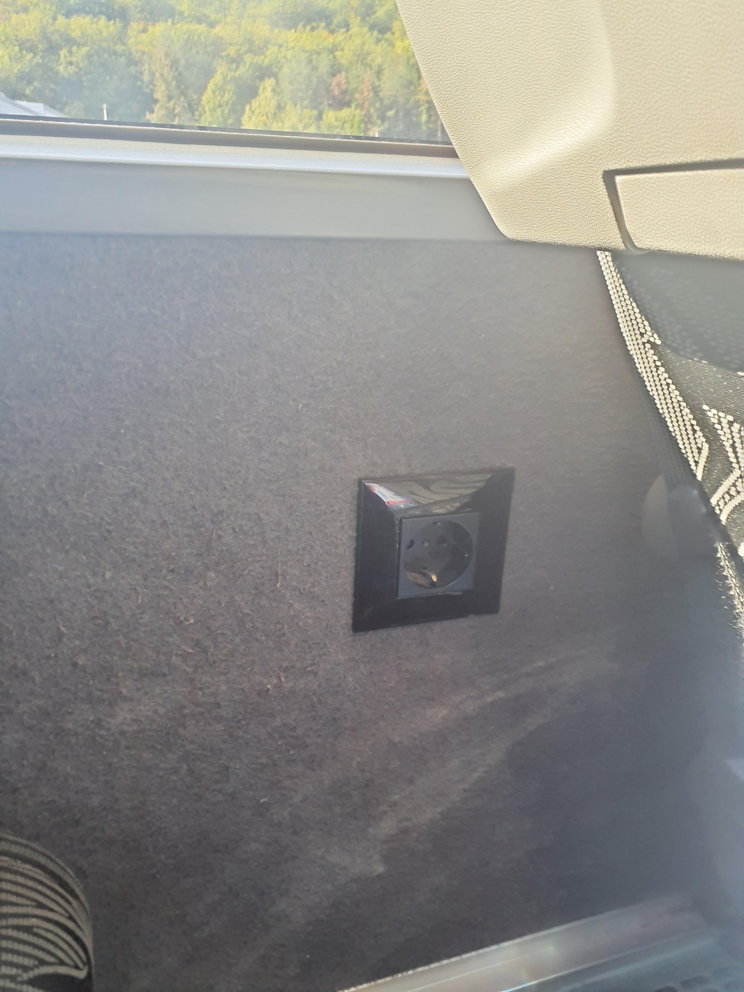 A modest power socket is positioned near the window seat.
