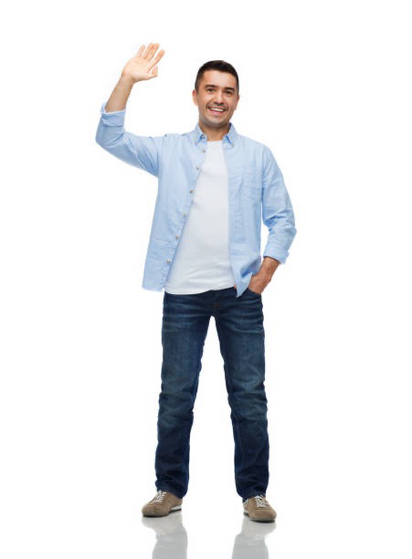 A stock photo of a man in a white T-shirt and unbuttoned, untucked dress shirt smiling and waving to camera
