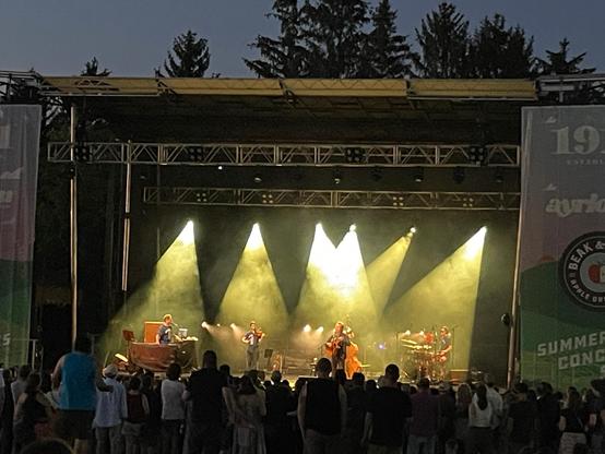 An outdoor stage lit up with yellow spotlights.