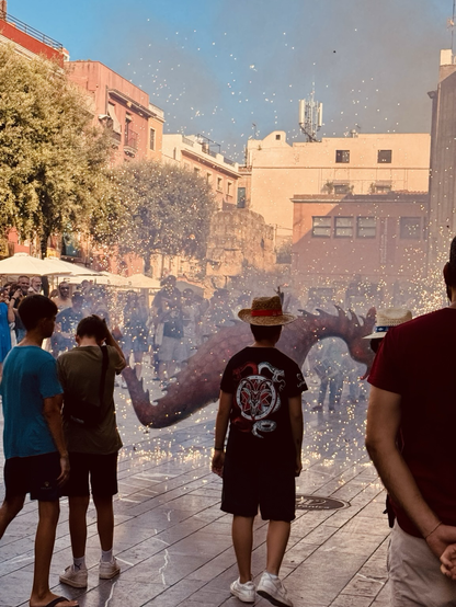 A dragon and small fireworks in a procession in Tarragona 