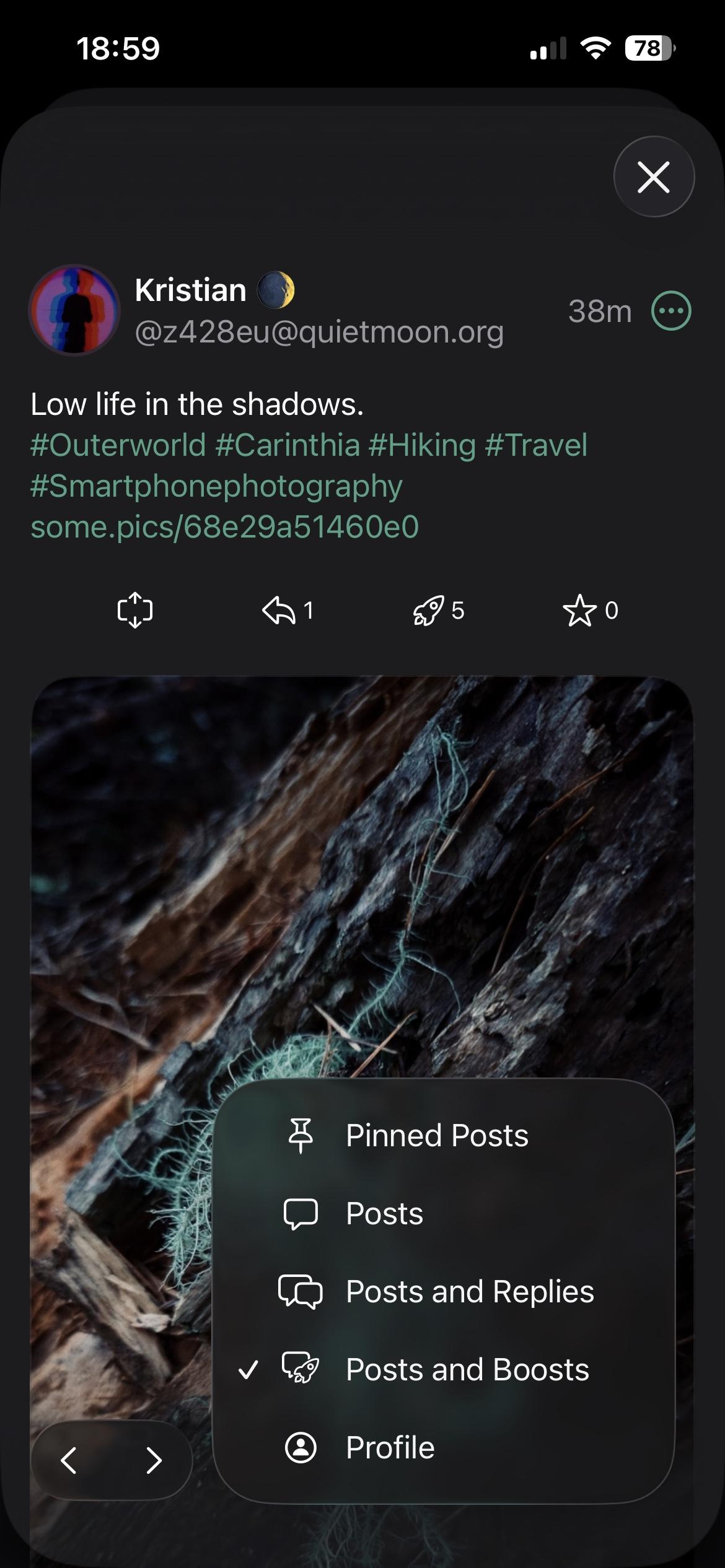 Screenshot of user posts timeline with Liquid Glass design in dark mode.