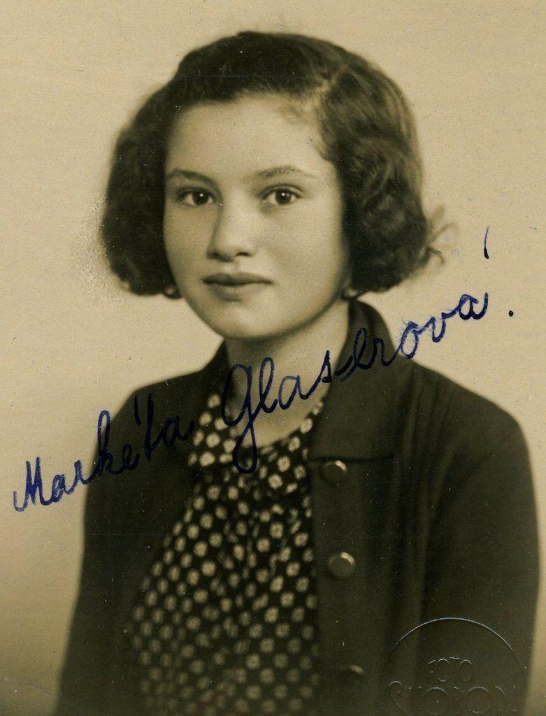 A portrait ID-style photo of a teenage girl. She has long, wavy hair covering her ears. She is wearing an unpinned sweater and a dotted blouse.