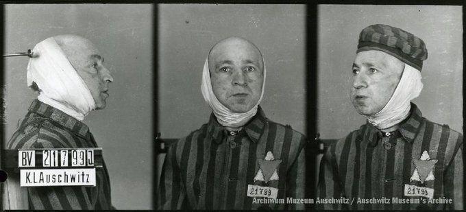 A mugshot registration photograph from Auschwitz. A man with a shaved head wearing a striped uniform photographed in three positions (profile and front with bare head and a photo with a slightly turned head with a hat on). The prisoner number is visible on a marking board on the left.
