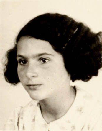 Black-and-white portrait of young girl with a thoughtful expression, wearing a light-patterned dress. Her hair is styled in curls framing her face.