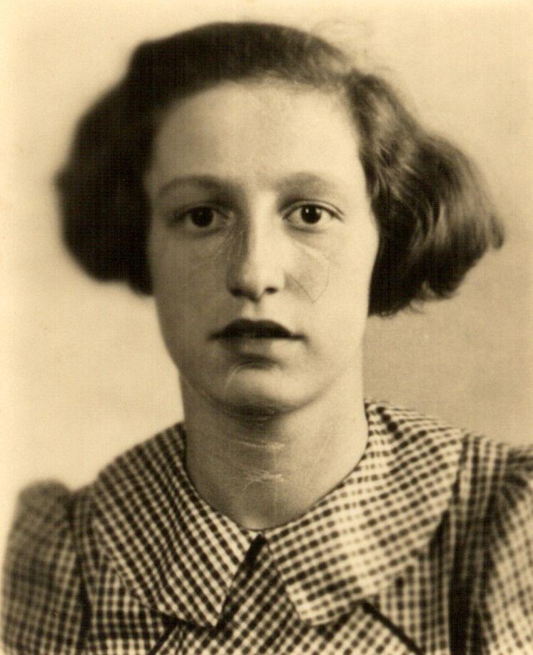 Vintage black-and-white portrait of a young girl in a checkered outfit with a serious expression, suggesting a mid-20th-century setting.