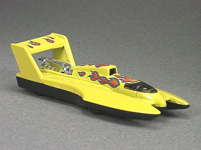 Released in 1996, Yellow Hydroplane-#2 of 4 of Flame Thrower Series with DW wheels. Tampo: Red/blue flames on top and airfoil. No flames on sides. Packaging: Blister Card. Metal Body, Plastic Base. Made in China. Scarcity: 2/10
