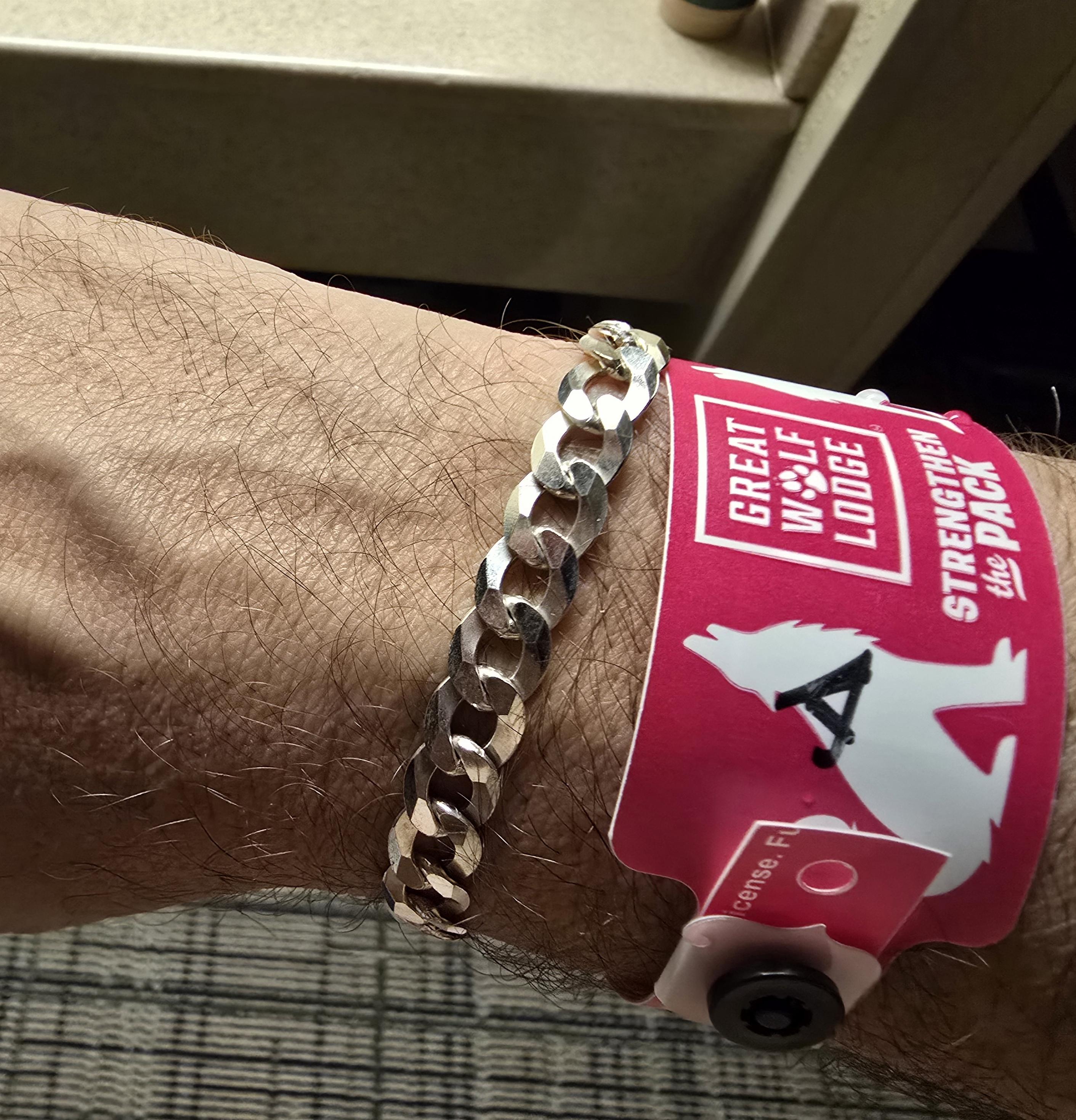 My Cuban link bracelet in silver with my Great Wolf Lodge ID badge.