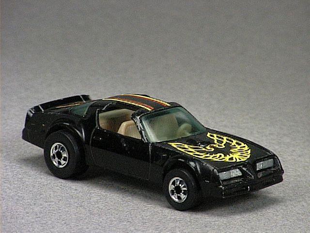 Released in 1978, Black Hot Bird of 1978 Hot Wheels with Black Wall wheels. Tampo: Orange and yellow stripe on top of car, yellow Firebird emblem on hood. Packaging: 1978 Blister. Metal Body, Metal Base. Made in Hong Kong. Scarcity: 2/10