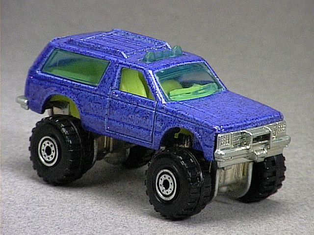 Released in 1993, Metal Flake Blue Blazer 4X4 of 1993 with Construction Tire wheels. Packaging: Blister Card. Metal Body, Metal Base. Made in Malaysia. Scarcity: 2/10