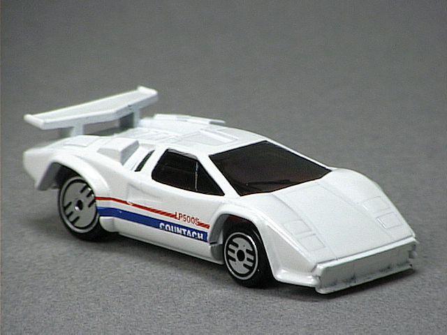 Released in 1989, Purple Lamborghini Countach of 1995 Model Series with Ultra Hot wheels. Tampo: Orange stripe on sides with 'Exp 3510. Packaging: Blister Card. Plastic Body, Metal Base. Made in Malaysia. Scarcity: 4/10