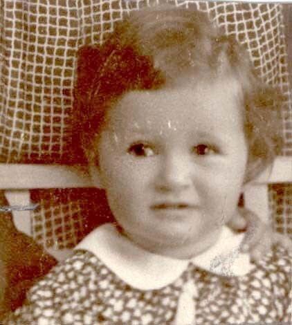 Vintage black and white photo of a young child with curly hair