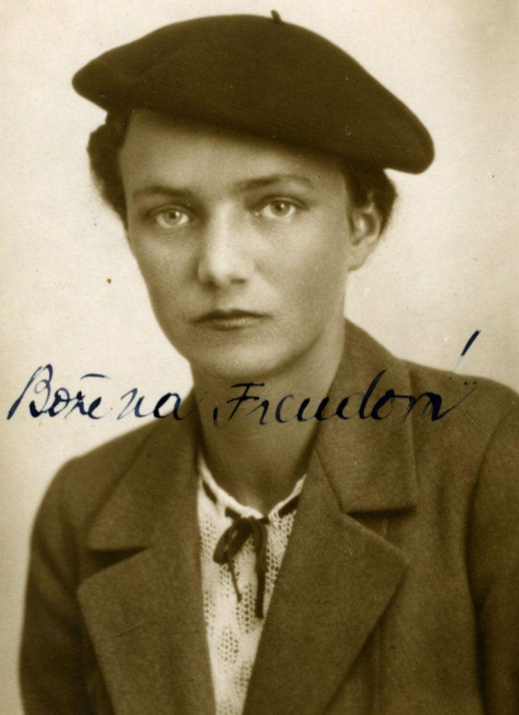 Vintage black-and-white photograph of a woman wearing a beret and a jacket with a necktie