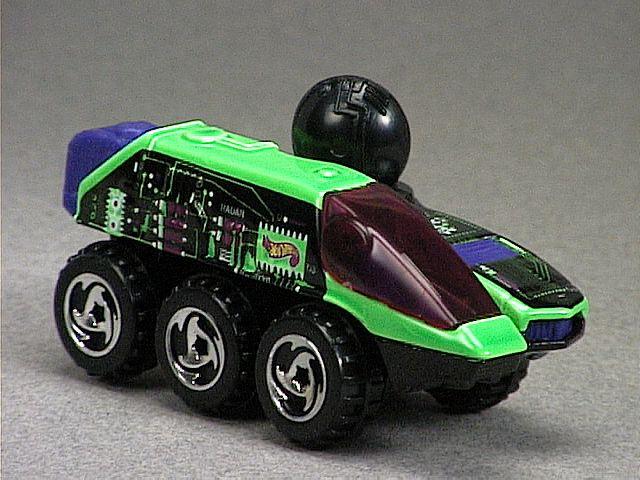 Released in 1998, Fluorescent Green Radar Ranger-#4 of 4 of Techno Bits Series with 3-Spoke Directional wheels. Notes: Purple plastic dish. Tampo: Black/white/purple circuit board on sides/top; Hot Wheels logo red side. Packaging: Blister Card. Metal Body, Metal Base. Made in Malaysia. Scarcity: 1/10