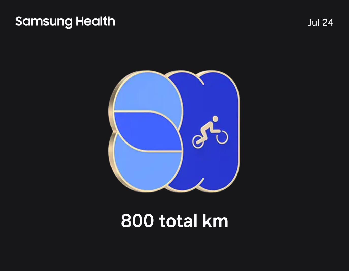 Image of an earned badge in the Samsung health app, signifying 800 km traveled by bike accumulated.

Stylized 800 in different shades of blue, outlined by gold, with a cyclist symbolized in the zero's against a black background.
White text, upper left reads:"Samsung Health". Upper right:"Jul 24". Centered below the badge:"800 total km".