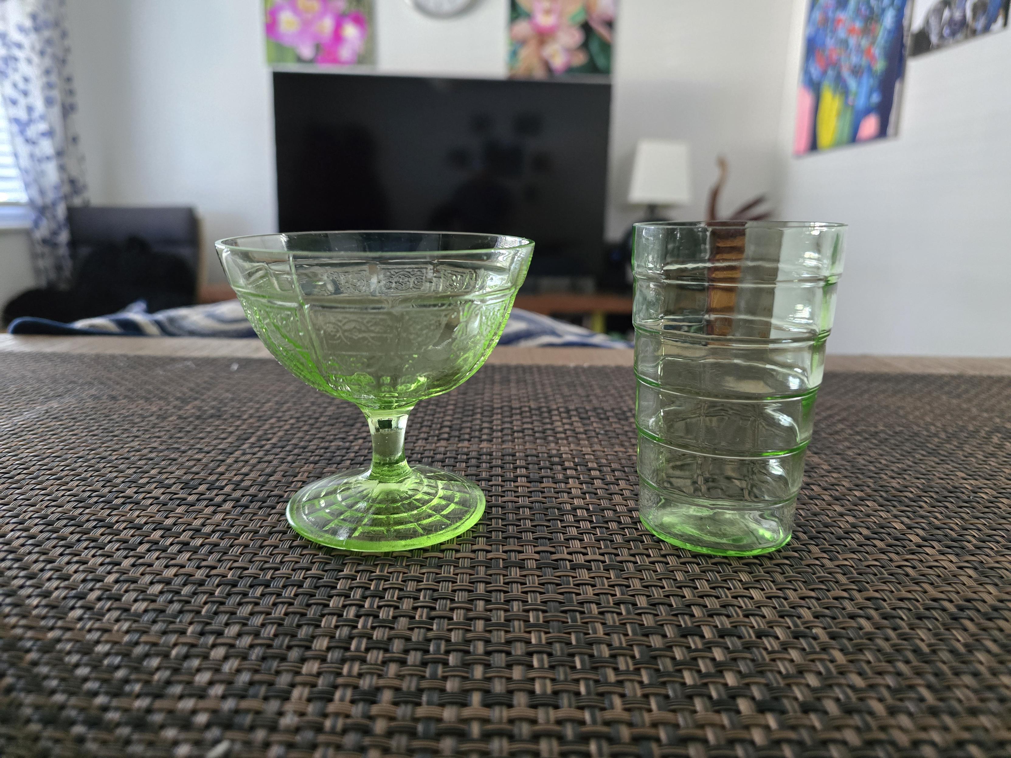 Uranium glass sitting on the bar in regular light, side view.