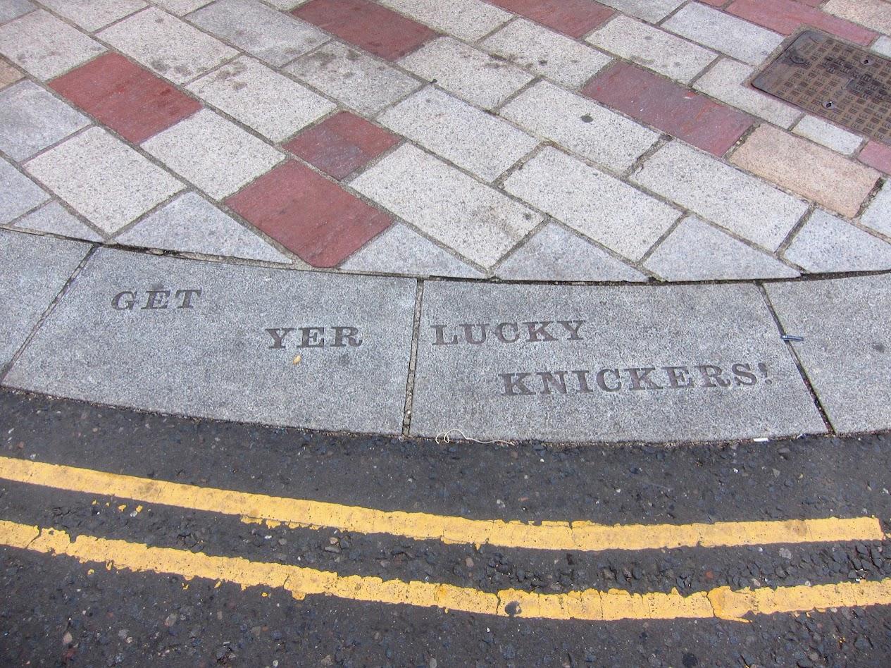 Carved into the kerb stone "GET YER LUCKY KNICKERS" plus double yellow lines