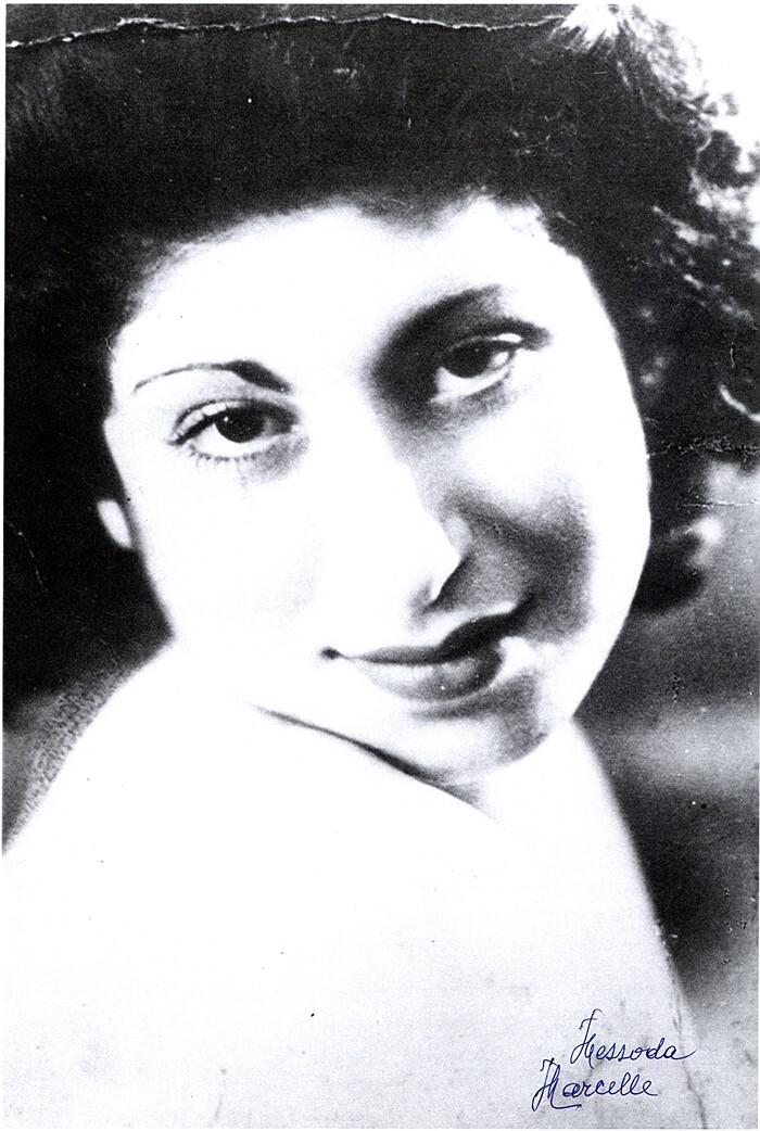 Vintage portrait of a woman featuring a close-up of her face with a soft focus and a signature at the bottom.