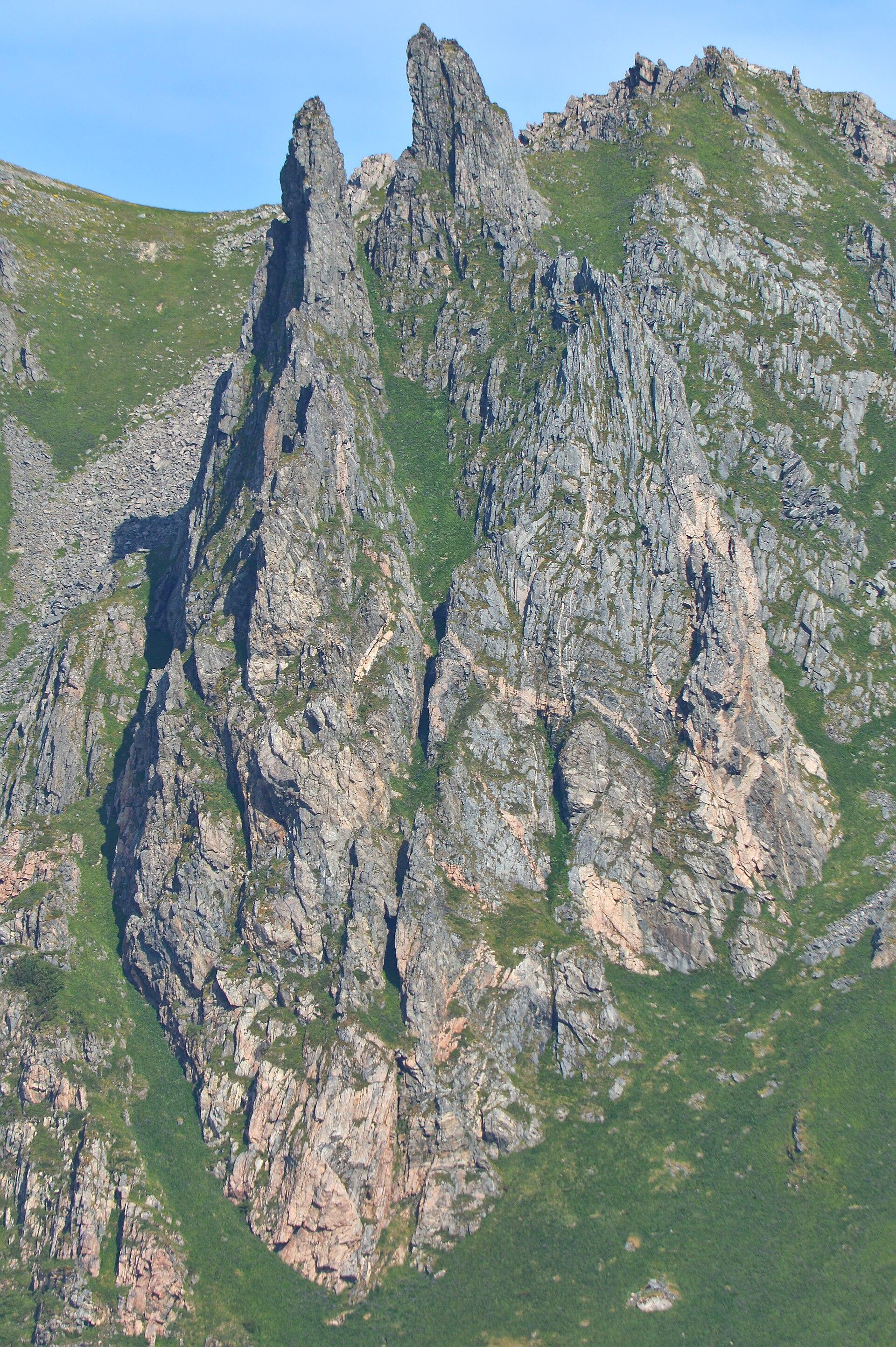 A photo of the jagged rocky side of a mountain.