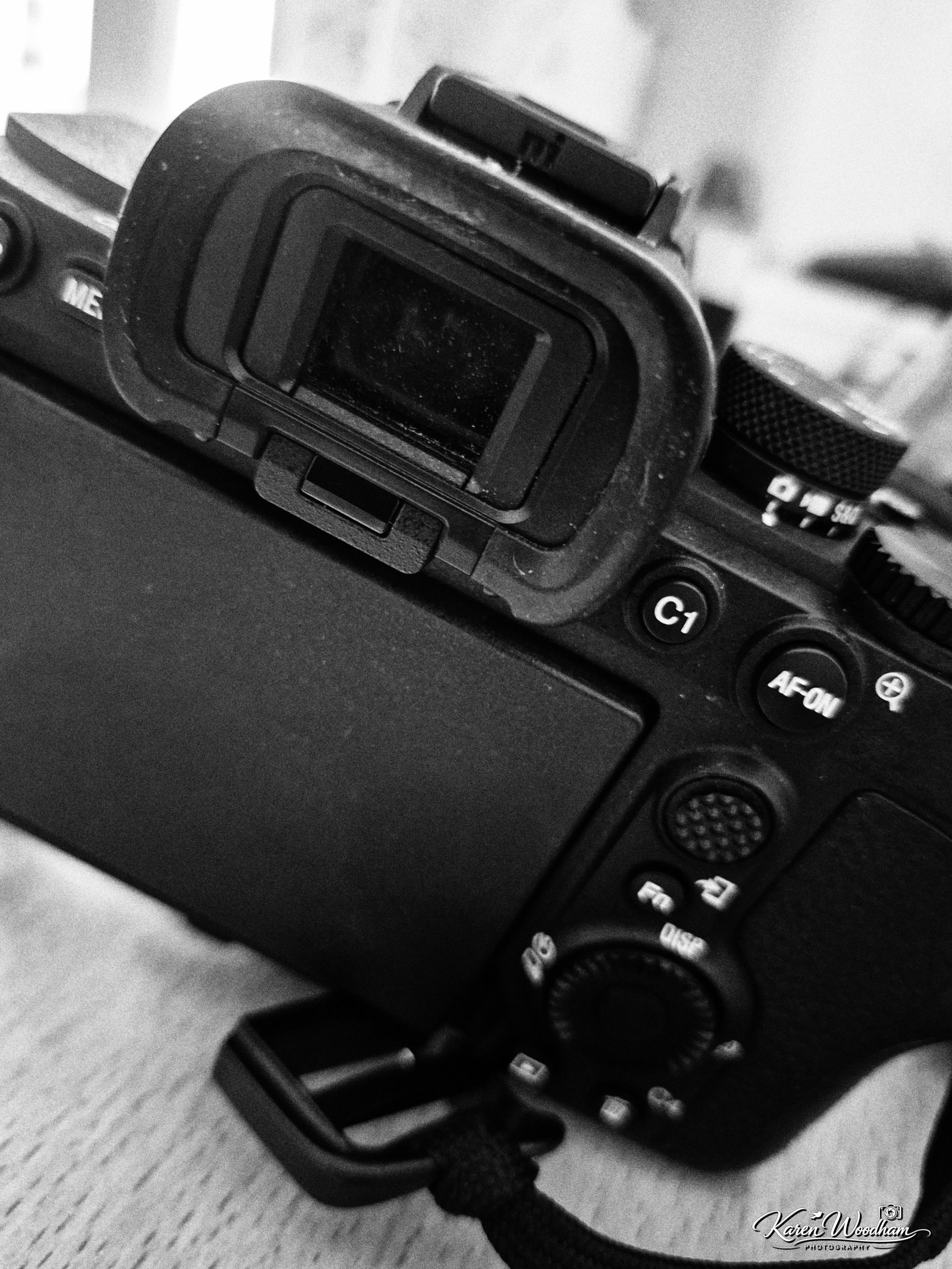 Close-up viewfinder and rear controls of a DSLR camera, showing a worn eyecup, C1 and AF‑ON buttons and dials to emphasize handling and ergonomics.
