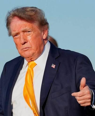 Donald Trump, Sept 05, appears to be wearing a dark hair piece or has had his hair dyed a darker color.