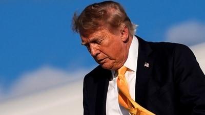 Donald Trump, Sept 05, appears to be wearing a dark hair piece or has had his hair dyed a darker color.
