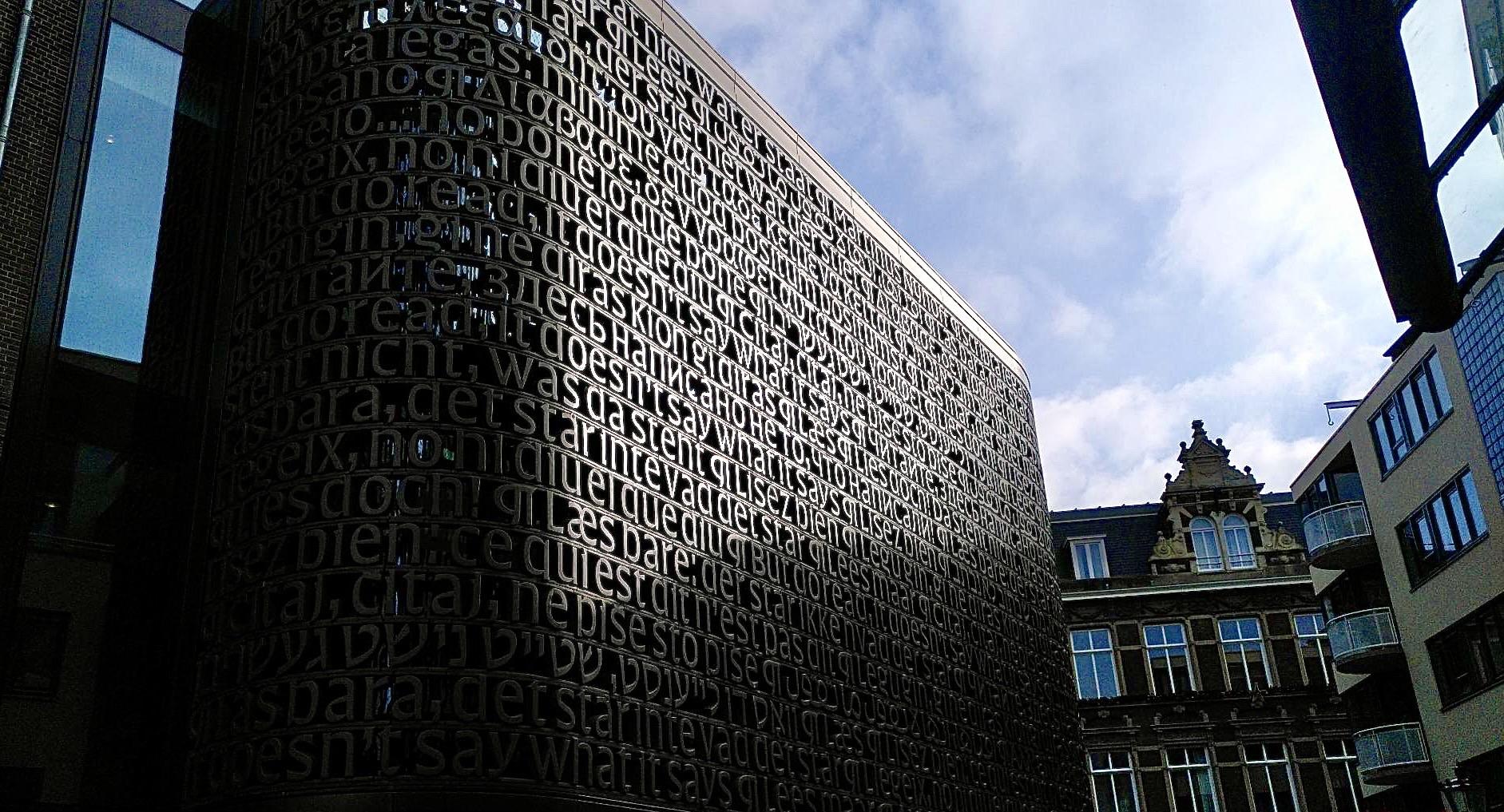 Facade of the UB in Amsterdam (University Library) showing parts of the poem Awater from Martinus Nijhoff. Several languages showing how close and how different mankind can be.