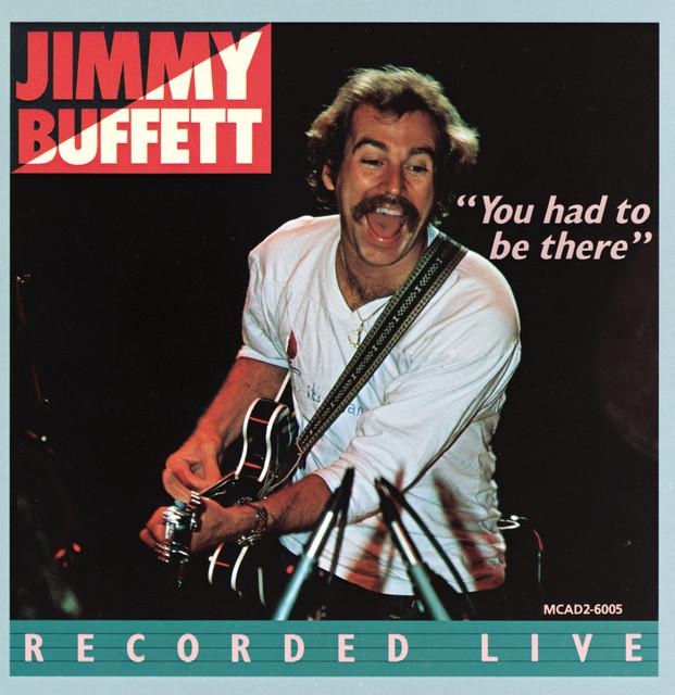 Jimmy Buffet "You had to be there" LIVE album cover.
forty-something dude with a guitar, having a whole lotta fun with his audience