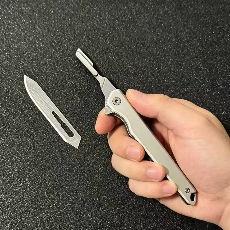 Knife handle with a folding bracket that holds a #60 scalpel blade.