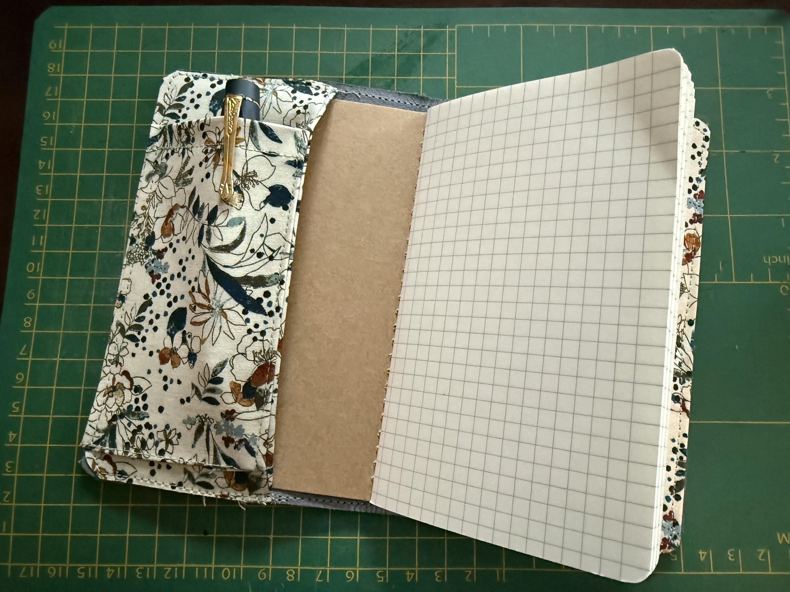 Inside a Lochby Notebook with grid paper and the cover has a pocket with a Kaweco fountain pen inside.