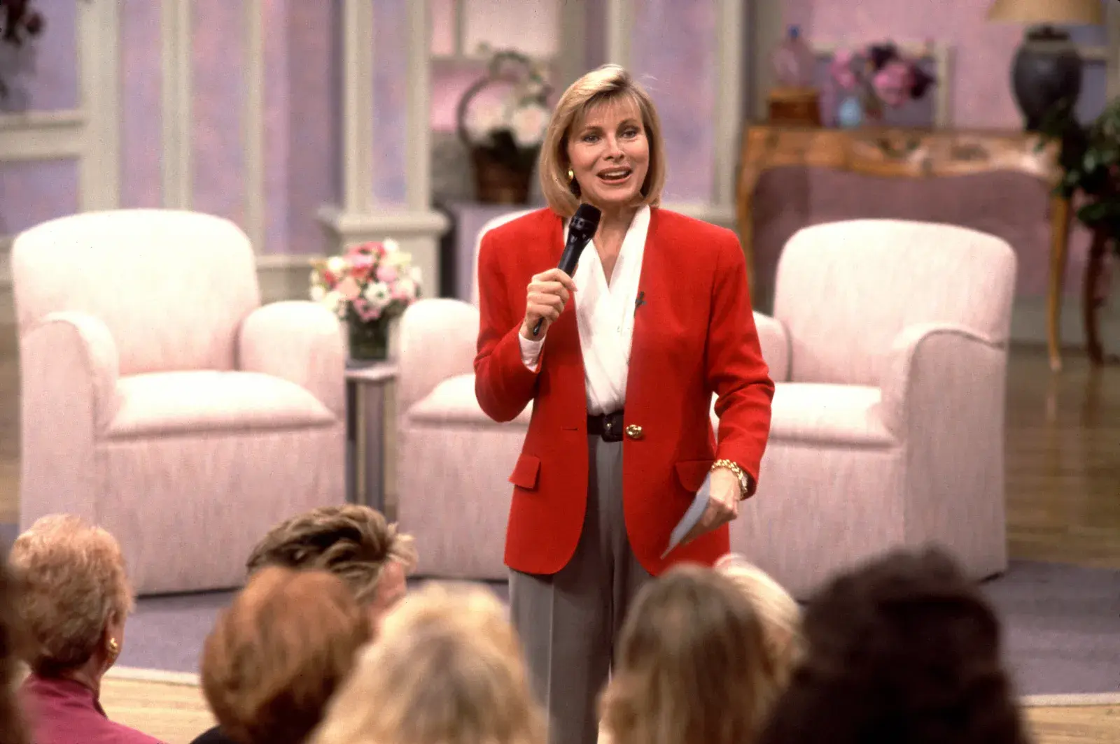 Jenny Jones Show host onstage in her red blazer