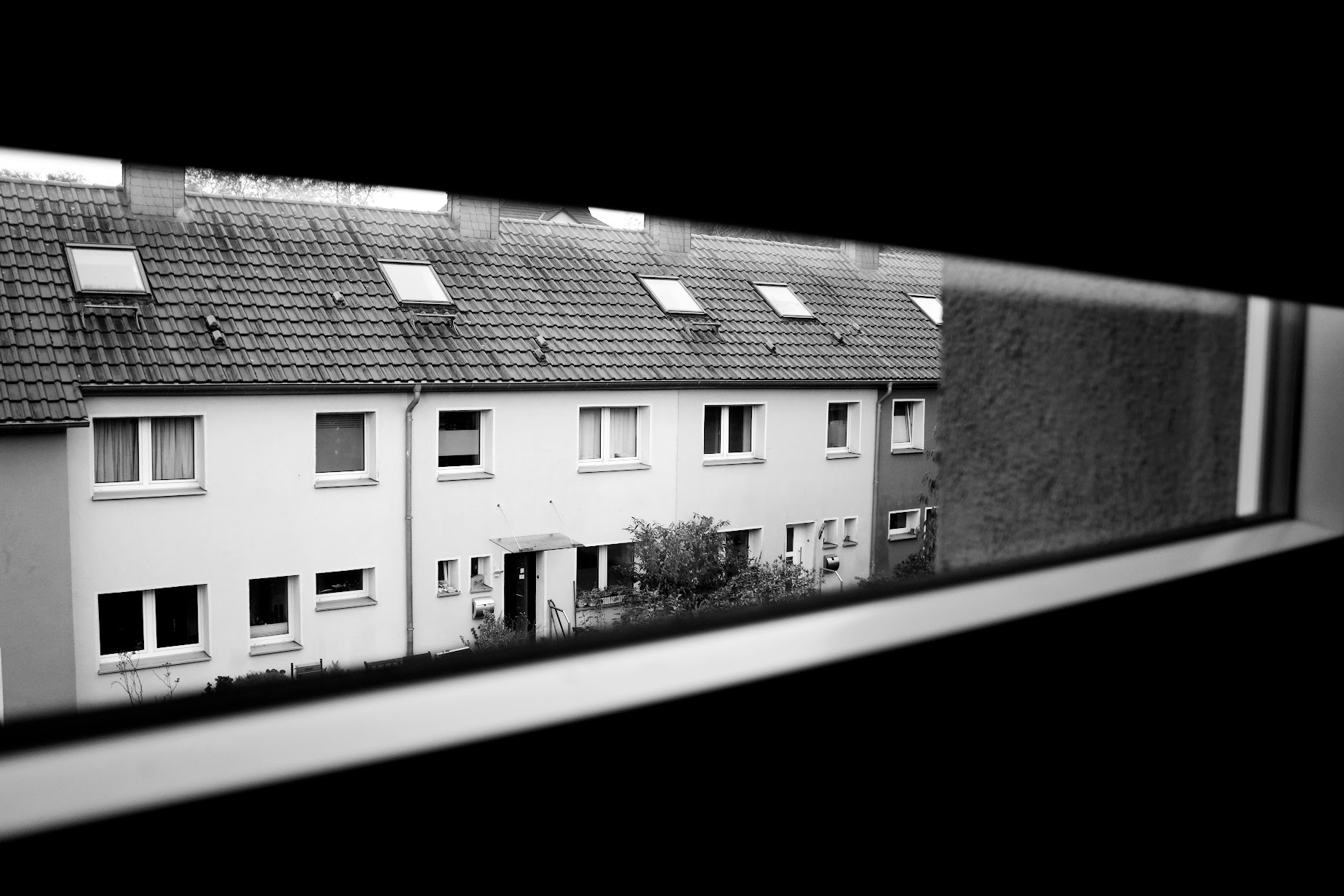 a view out of a window of a row of houses